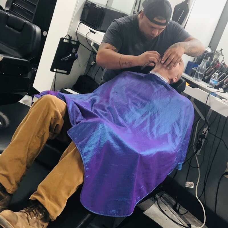 Barber detail work on a scalp fade