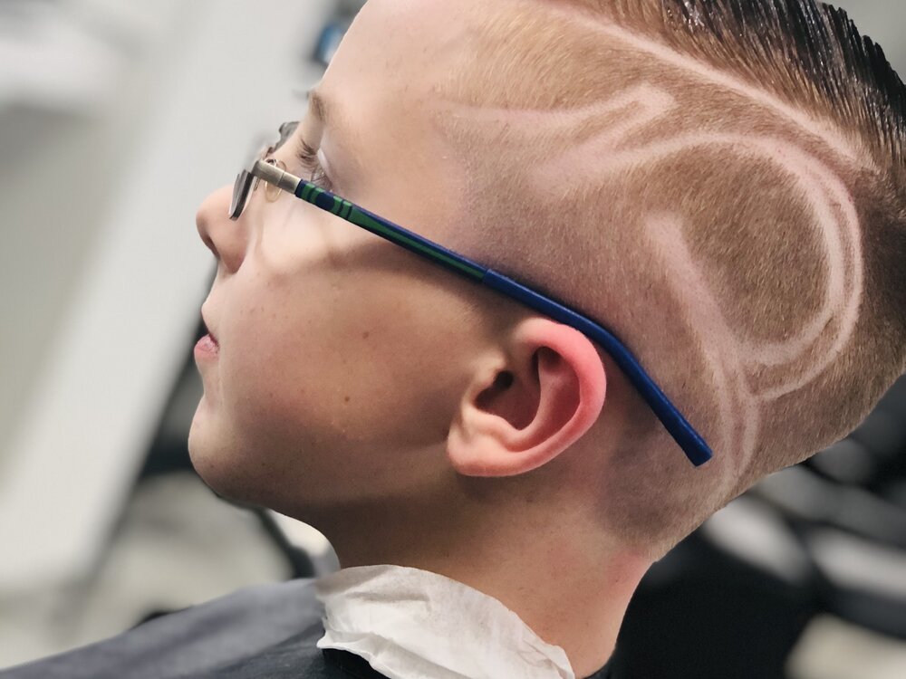 Custom shaved line art design at Creations by G Barbershop